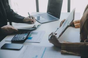 Audit concept,Administrator business man financial inspector and secretary making report calculating balance. Internal Revenue Service checking document. photo