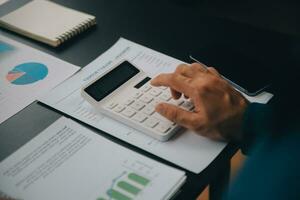 Financial Business team present. Business man hands hold documents with financial statistic stock photo, discussion, and analysis report data the charts and graphs. Finance Financial concept photo