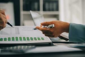 Financial Business team present. Business man hands hold documents with financial statistic stock photo, discussion, and analysis report data the charts and graphs. Finance Financial concept photo