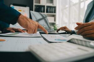 Financial Business team present. Business man hands hold documents with financial statistic stock photo, discussion, and analysis report data the charts and graphs. Finance Financial concept photo