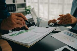 Financial Business team present. Business man hands hold documents with financial statistic stock photo, discussion, and analysis report data the charts and graphs. Finance Financial concept photo