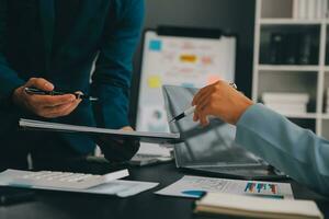 Financial Business team present. Business man hands hold documents with financial statistic stock photo, discussion, and analysis report data the charts and graphs. Finance Financial concept photo