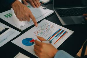 Financial Business team present. Business man hands hold documents with financial statistic stock photo, discussion, and analysis report data the charts and graphs. Finance Financial concept photo