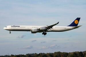 Munich, Germany, 2017 - Lufthansa Airbus A340-600 D-AIHK passenger plane arrival and landing at Munich Airport photo
