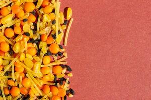 Various dried food on a red background. Top view of legumes. High protein foods. Flat lay. photo