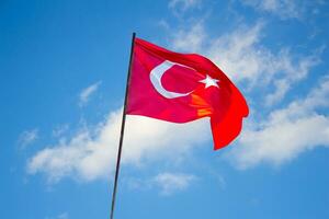 Turkish flag against blue cloudy sky. April 23, August 30, October 29 celebration photo. photo