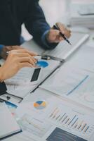Financial analysts analyze business financial reports on a digital tablet planning investment project during a discussion at a meeting of corporate showing the results of their successful teamwork. photo