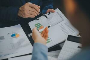 Financial Business team present. Business man hands hold documents with financial statistic stock photo, discussion, and analysis report data the charts and graphs. Finance Financial concept photo
