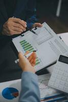 Financial Business team present. Business man hands hold documents with financial statistic stock photo, discussion, and analysis report data the charts and graphs. Finance Financial concept photo