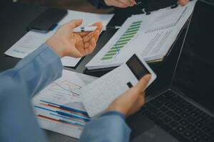 Financial Business team present. Business man hands hold documents with financial statistic stock photo, discussion, and analysis report data the charts and graphs. Finance Financial concept photo