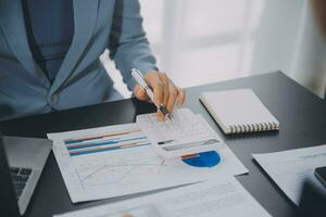 Financial Business team present. Business man hands hold documents with financial statistic stock photo, discussion, and analysis report data the charts and graphs. Finance Financial concept photo