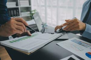 Financial Business team present. Business man hands hold documents with financial statistic stock photo, discussion, and analysis report data the charts and graphs. Finance Financial concept photo