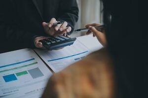 Financial analysts analyze business financial reports on a digital tablet planning investment project during a discussion at a meeting of corporate showing the results of their successful teamwork. photo