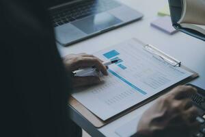 Financial analysts analyze business financial reports on a digital tablet planning investment project during a discussion at a meeting of corporate showing the results of their successful teamwork. photo