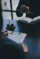 Business and lawyers discussing contract papers with brass scale on desk in office. Law, legal services, advice, justice and law concept picture with film grain effect photo