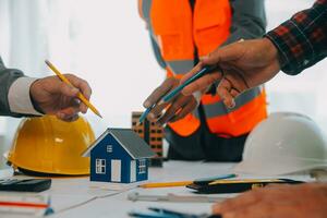 Construction and structure concept of Engineer or architect meeting for project working with partner and engineering tools on model building and blueprint in working site, contract for both companies. photo
