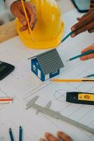 Construction and structure concept of Engineer or architect meeting for project working with partner and engineering tools on model building and blueprint in working site, contract for both companies. photo