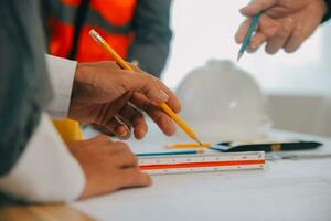 Construction and structure concept of Engineer or architect meeting for project working with partner and engineering tools on model building and blueprint in working site, contract for both companies. photo