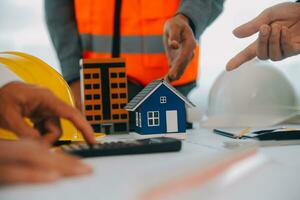 Construction and structure concept of Engineer or architect meeting for project working with partner and engineering tools on model building and blueprint in working site, contract for both companies. photo