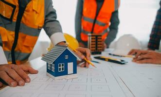 Construction and structure concept of Engineer or architect meeting for project working with partner and engineering tools on model building and blueprint in working site, contract for both companies. photo