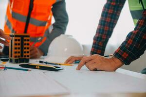Construction and structure concept of Engineer or architect meeting for project working with partner and engineering tools on model building and blueprint in working site, contract for both companies. photo
