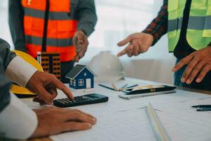 Construction and structure concept of Engineer or architect meeting for project working with partner and engineering tools on model building and blueprint in working site, contract for both companies. photo