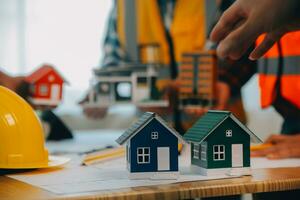 Construction and structure concept of Engineer or architect meeting for project working with partner and engineering tools on model building and blueprint in working site, contract for both companies. photo