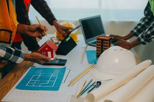 Construction and structure concept of Engineer or architect meeting for project working with partner and engineering tools on model building and blueprint in working site, contract for both companies. photo