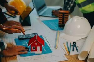 Construction and structure concept of Engineer or architect meeting for project working with partner and engineering tools on model building and blueprint in working site, contract for both companies. photo