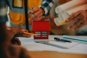 Construction and structure concept of Engineer or architect meeting for project working with partner and engineering tools on model building and blueprint in working site, contract for both companies. photo