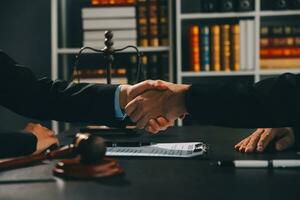 Businessman shaking hands to seal a deal with his partner lawyers or attorneys discussing a contract agreement photo