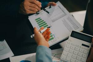 Financial Business team present. Business man hands hold documents with financial statistic stock photo, discussion, and analysis report data the charts and graphs. Finance Financial concept photo