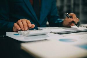 Financial Business team present. Business man hands hold documents with financial statistic stock photo, discussion, and analysis report data the charts and graphs. Finance Financial concept photo