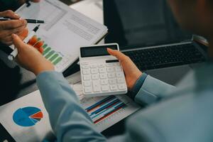Financial Business team present. Business man hands hold documents with financial statistic stock photo, discussion, and analysis report data the charts and graphs. Finance Financial concept photo