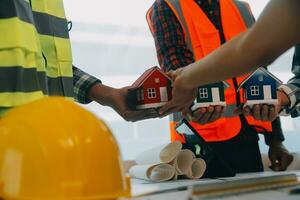 Construction and structure concept of Engineer or architect meeting for project working with partner and engineering tools on model building and blueprint in working site, contract for both companies. photo