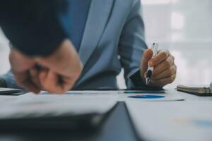 Financial Business team present. Business man hands hold documents with financial statistic stock photo, discussion, and analysis report data the charts and graphs. Finance Financial concept photo