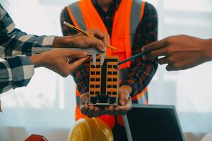 Construction and structure concept of Engineer or architect meeting for project working with partner and engineering tools on model building and blueprint in working site, contract for both companies. photo