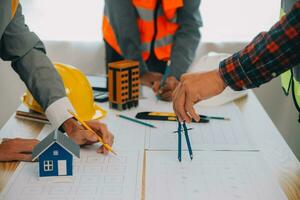 Construction and structure concept of Engineer or architect meeting for project working with partner and engineering tools on model building and blueprint in working site, contract for both companies. photo