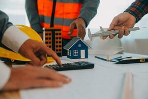 Construction and structure concept of Engineer or architect meeting for project working with partner and engineering tools on model building and blueprint in working site, contract for both companies. photo