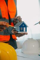 Construction and structure concept of Engineer or architect meeting for project working with partner and engineering tools on model building and blueprint in working site, contract for both companies. photo