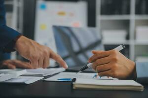Financial Business team present. Business man hands hold documents with financial statistic stock photo, discussion, and analysis report data the charts and graphs. Finance Financial concept photo