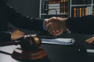 Businessman shaking hands to seal a deal with his partner lawyers or attorneys discussing a contract agreement photo