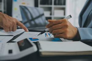 Financial Business team present. Business man hands hold documents with financial statistic stock photo, discussion, and analysis report data the charts and graphs. Finance Financial concept photo