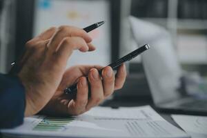 Financial Business team present. Business man hands hold documents with financial statistic stock photo, discussion, and analysis report data the charts and graphs. Finance Financial concept photo