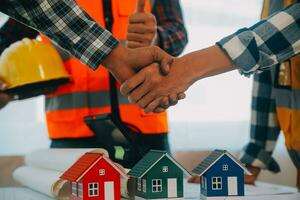 Construction and structure concept of Engineer or architect meeting for project working with partner and engineering tools on model building and blueprint in working site, contract for both companies. photo