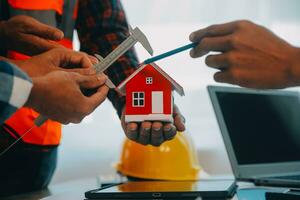 Construction and structure concept of Engineer or architect meeting for project working with partner and engineering tools on model building and blueprint in working site, contract for both companies. photo