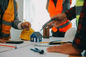 Construction and structure concept of Engineer or architect meeting for project working with partner and engineering tools on model building and blueprint in working site, contract for both companies. photo