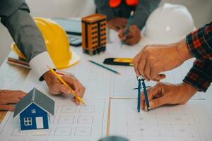 Construction and structure concept of Engineer or architect meeting for project working with partner and engineering tools on model building and blueprint in working site, contract for both companies. photo