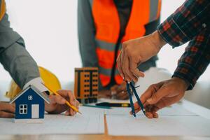 Construction and structure concept of Engineer or architect meeting for project working with partner and engineering tools on model building and blueprint in working site, contract for both companies. photo