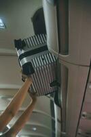 Cabin crew lift luggage bag in airplane . Airline transportation and tourism concept. photo